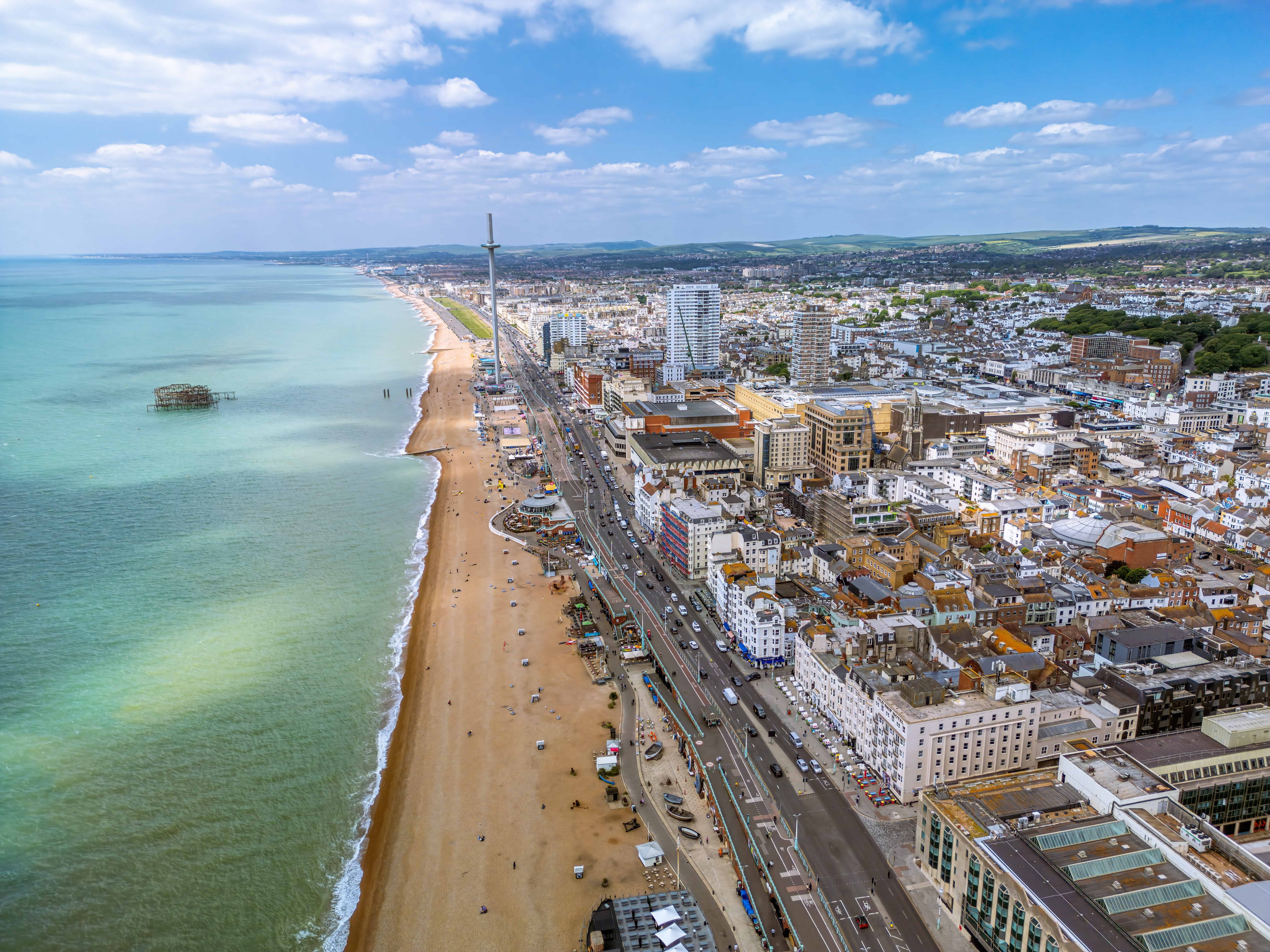 Aerial view of Brighton seafront with Brighton i360, beach, and city skyline, showcasing modern coastal living and digital connectivity in Brighton.