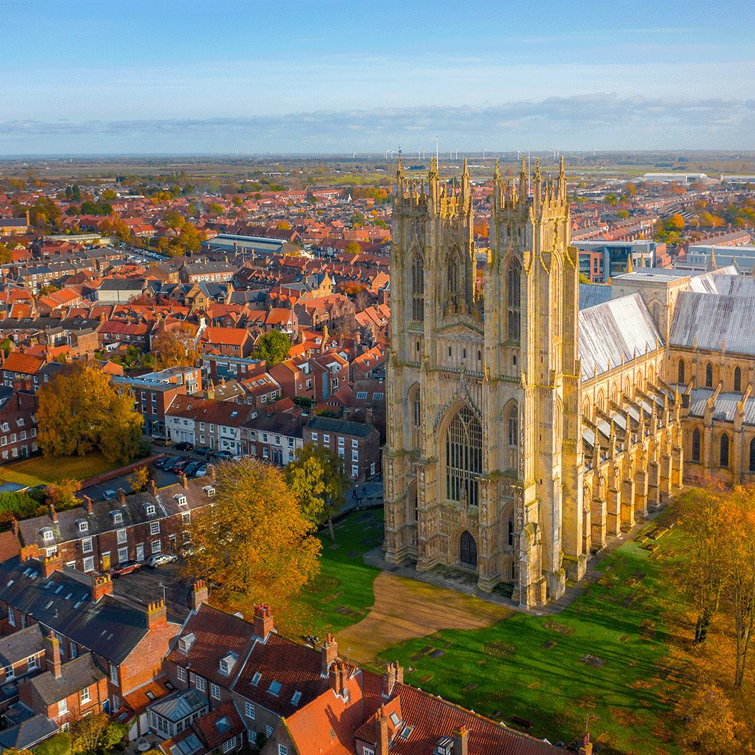 Aerial view of Beverley Minster in Beverley, East Riding of Yorkshire, surrounded by historic red-roofed houses.