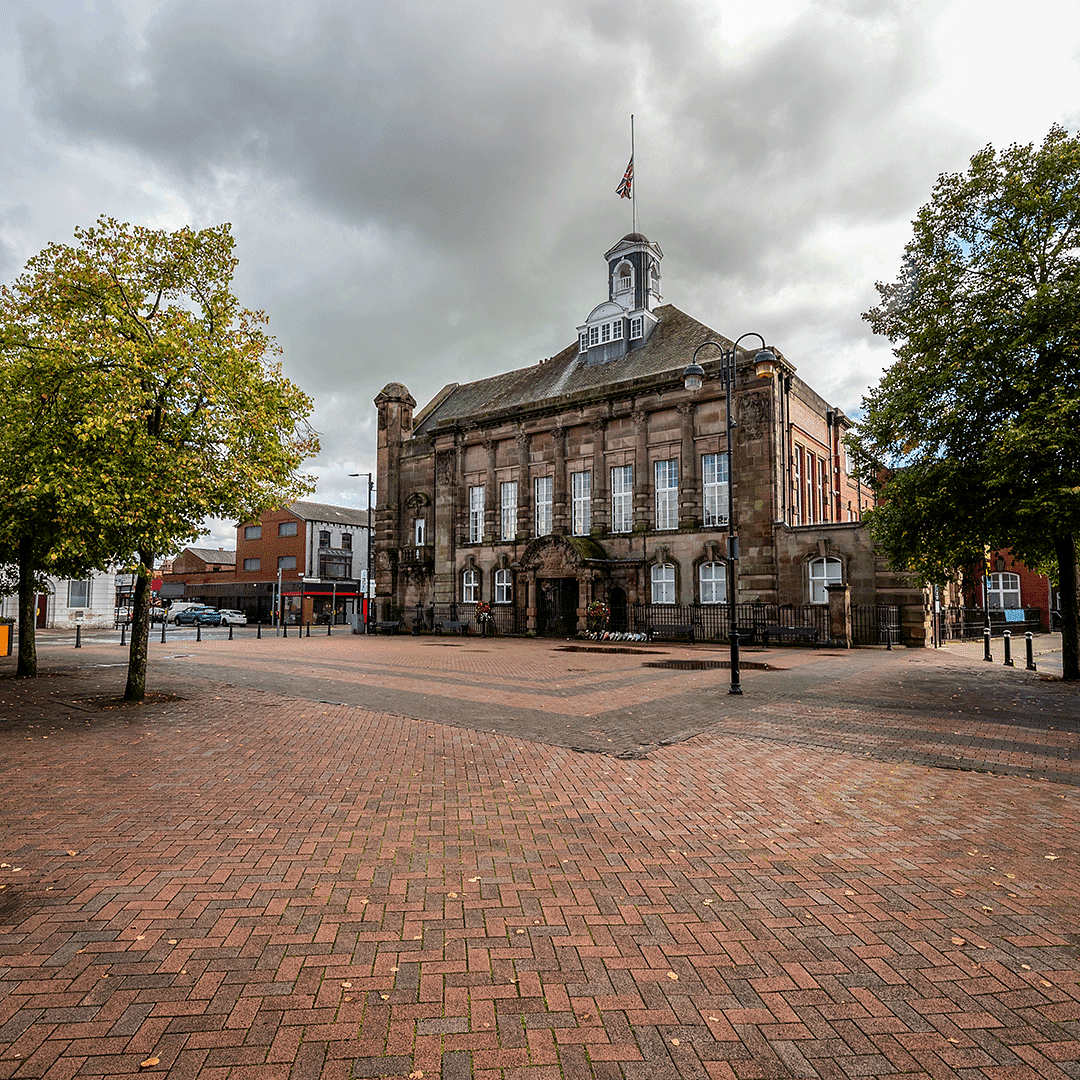 Leigh Town Hall in Greater Manchester, historic civic building with clock tower and surrounding square.